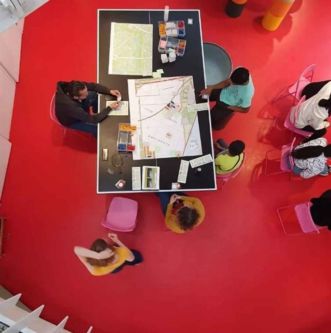 We see see teens from above, on their heads, planning their own space